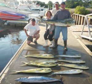 gulf-stream-north-myrtle-beach-fishing-charters men standing on the dock with whaoo, mahi laying on the dock from a gulf stream trip with North Myrtle Beach Fishing Charters